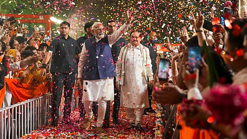 Prime Minister Narendra Modi and BJP National President JP Nadda greet supporters upon their arrival for a meeting at the party headquarters as the party leads in the Lok Sabha elections amid the counting of votes, in New Delhi, Tuesday, June 4, 2024.