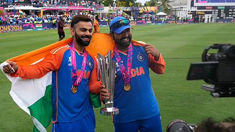 India's Virat Kohli, left, and captain Rohit Sharma pose with the winners trophy after defeating South Africa in the ICC Men's T20 World Cup final cricket match at Kensington Oval in Bridgetown, Barbados, Saturday, June 29, 2024.