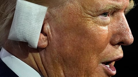 Donald Trump at the Republican convention wearing a bandage on his ear.