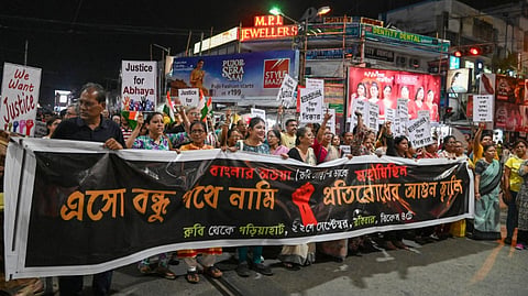 People take part in a protest march over the alleged sexual assault and murder of a trainee doctor, in Kolkata, Sunday, Sept. 22, 2024.