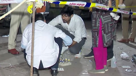 Forensic team investigates at the site where former Maharashtra minister Baba Siddique was shot dead by three assailants, in Mumbai, Saturday night, Oct. 12, 2024.