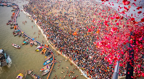 Devotees preparing for holy dip on the first day of Maha Kumbh Mela 2025, in Prayagraj, Uttar Pradesh, Monday, Jan. 13, 2025.