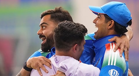 Virat Kohli with teammates celebrate after their win against New Zealand in the ICC Champions Trophy 2025 final cricket match, in Dubai, UAE, Sunday, March 9, 2025.