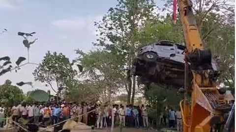 Van lands in water-filled well