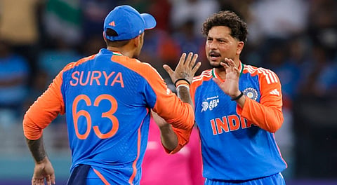In this image released on Sept. 10, 2025, India's Kuldeep Yadav celebrates with captain Suryakumar Yadav after taking the wicket of UAE's Rahul Chopra during the Asia Cup 2025 match between India and UAE, in Dubai.