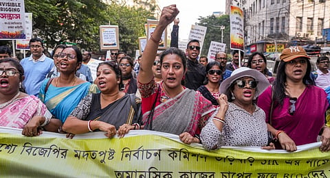 Booth level officers who are engaged in the ongoing special intensive revision (SIR) of electoral rolls in West Bengal raise slogans during a protest march to the office of the Chief Electoral Officer (CEO over alleged excessive work pressure, in Kolkata, Monday, Nov. 24, 2025.