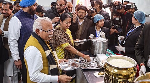 Union Minister of Housing and Urban Affairs Manohar Lal, Delhi Chief Minister Rekha Gupta and minister Ashish Sood during the inauguration of an 'Atal Canteen' to commemorate the birth anniversary of former prime minister Atal Bihari Vajpayee, in New Delhi, Thursday, Dec. 25, 2025.