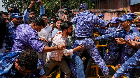 Youth Congress (IYC) activists clash with security personnel during a protest at the NSIC complex following the leak of the NEET-UG 2026 paper, in New Delhi, Wednesday, May 13, 2026.