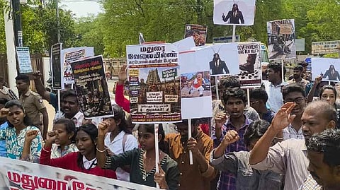 Members of the Democratic Youth Federation of India (DYFI) and Students' Federation of India (SFI) take out a procession holding placards with pictures of cockroaches, demanding employment opportunities for youths, in Madurai, Tamil Nadu, Sunday, May 24, 2026.