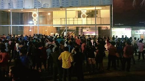 People gather for an early morning show at a cinema in Chennai.