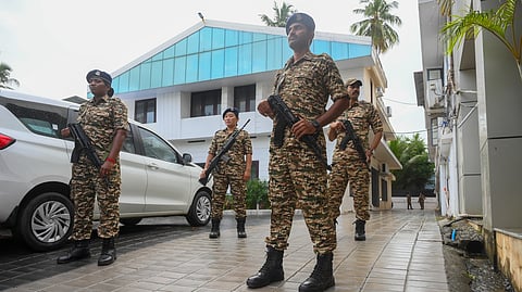 Security personnel stand guard outside the residence of former Kerala Chief Minister Pinarayi Vijayan after the Enforcement Directorate (ED) conducted a raid at Vijayan's residence as part of its investigation against his daughter in the CMRL money laundering case, in Thiruvananthapuram, early Wednesday, May 27, 2026.