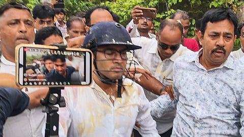 TMC General Secretary Abhishek Banerjee wears a helmet after stones, shoes and eggs were hurled at him during his visit to the families of post-poll violence victims, in Sonarpur, West Bengal, Saturday, May 30, 2026.