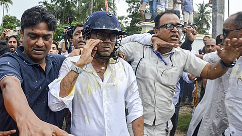 TMC General Secretary Abhishek Banerjee wears a helmet after stones, shoes and eggs were hurled at him during his visit to meet families of post-poll violence victims, in Sonarpur, West Bengal, Saturday, May 30, 2026.