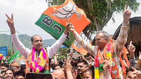 Former Himachal Pradesh chief minister and LoP in state Legislative Assembly Jai Ram Thakur, left, and BJP MLA Anil Sharma celebrate after the party leads in the Mandi Municipal Corporations elections, Sunday, May 31, 2026.