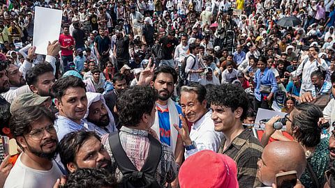 Cockroach Janta Party (CJP) founder Abhijeet Dipke, in blue, its spokespersons Saurav Das and Vijeta Dahiya, and Climate activist Sonam Wangchuk during a protest demanding the resignation of Union Education Minister Dharmendra Pradhan over alleged examination-related lapses, at the Jantar Mantar, in New Delhi, Saturday, June 6, 2026.