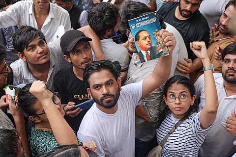 Cockroach Janta Party (CJP) founder Abhijeet Dipke holds a copy of the autobiography of Dr. BR Ambedkar