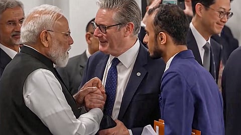 Prime Minister Narendra Modi interacts with Britain's Prime Minister Keir Starmer during a working session at the G7 Summit, in Evian-les-Bains, France.