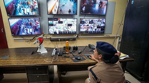 A police official keeps a vigil through CCTV cameras from a control room, ahead of the NEET-UG re-examination, at the Charbagh Railway Station, in Lucknow, Uttar Pradesh, Saturday, June 20, 2026.