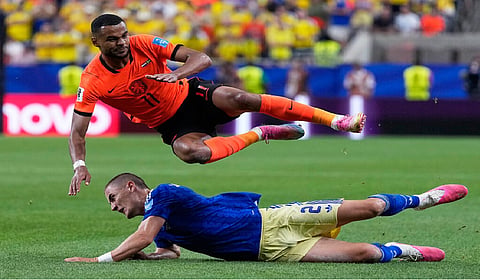 Brian Brobbey and the Dutch roll in the rain to a 3-1 win over Tunisia to top World Cup Group F