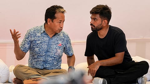 Activist Sonam Wangchuk in a conversation with Cockroach Janta Party (CJP) founder Abhijeet Dipke during a protest demanding the resignation of Union Education Minister Dharmendra Pradhan in the wake of the alleged NEET paper leak, at Jantar Mantar in New Delhi, Sunday, June 28, 2026.