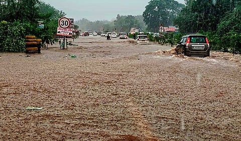 Vehicles wade through a waterlogged stretch of the Mumbai-Goa Highway on Bhandanwadi Road following heavy rain, in Raigad, Maharashtra, Saturday, July 4, 2026.