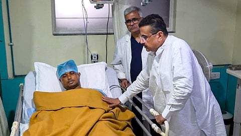 West Bengal Chief Minister Suvendu Adhikari interacts with a police personnel, who got injured in a mob lynching incident on Sunday, when the mortal remains of an 11-year-old girl were found in Baruipur, followed by an alleged gangrape and murder case, in Kolkata.