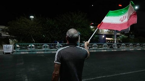 A man waves Iran flag in Tehran