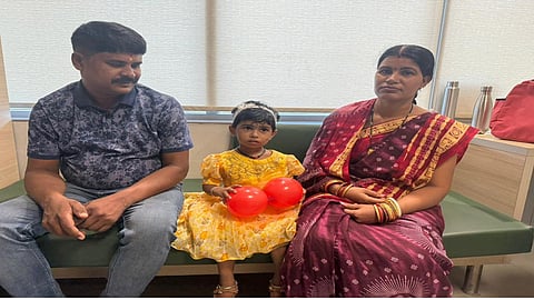 Two-year-old Priyanshi after the successful surgery sitting along with her parents Rajendra and Pushpalatha Panda.