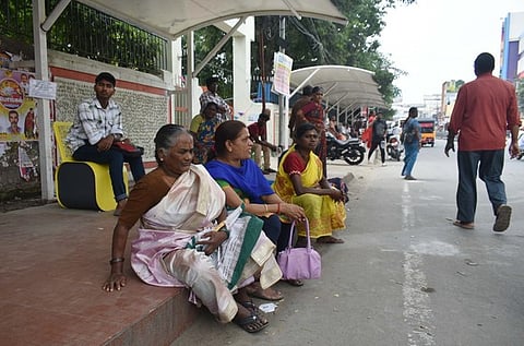 The passengers and the public utilising the town Hall bus stop in Coimbatore