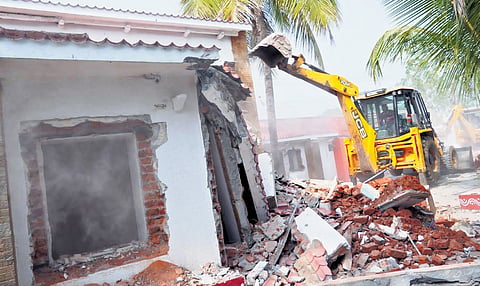 A JCB demolishes a house belonging to BJP MLA KV Ramana Reddy after he decided to set an example by allowing the razing in public interest, in Kamareddy on Friday