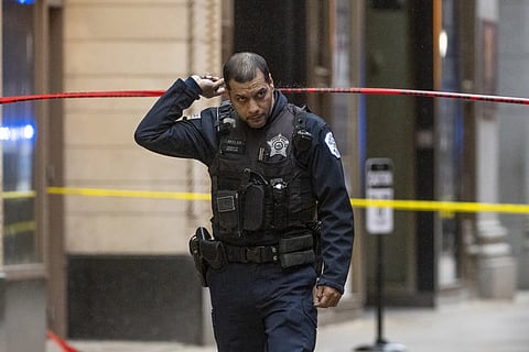 A police detective works the scene where two high school students were shot and killed in Chicago, Friday, Jan 26, 2024.