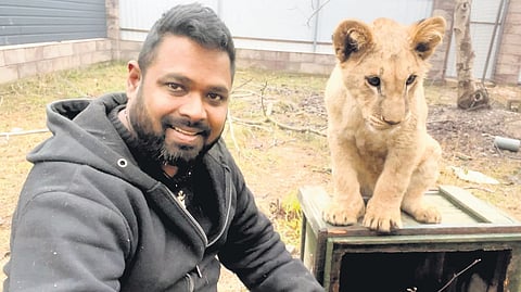 Dr Giri Kumar Patil with his adopted lion cub in Lviv, Ukraine.