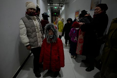 Residents displaced in the aftermath of an earthquake arrive at a school dormitory used as temporary shelter in Wushi county in China's western Xinjiang region on Tuesday, Jan. 23, 2024.