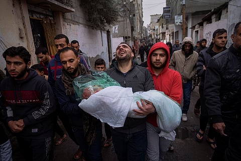 Mohammad Shouman carries the body of his daughter, Masa, who was killed in an Israeli bombardment of the Gaza Strip, during her funeral in Rafah, southern Gaza, Wednesday, Jan. 17, 2024.