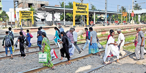 Pedestrians are forced to cross the rail tracks at Veppampattu station owing to a lack of a foot-overbridge.