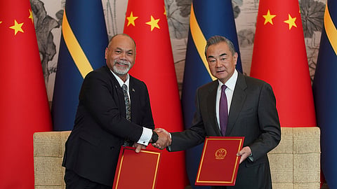 Chinese Foreign Minister Wang Yi, right and Minister of Foreign Affairs and Trade of Nauru Lionel Aingimea shake hands in Beijing on Jan. 24, 2024.