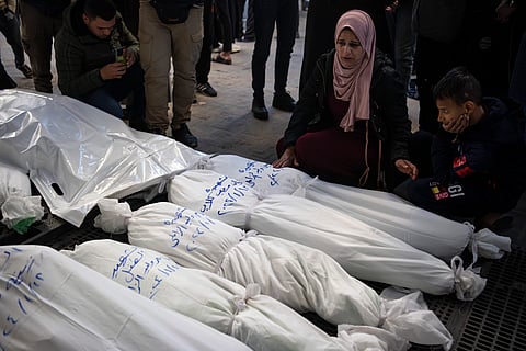 Palestinians mourn their relatives killed in the Israeli bombardment of the Gaza Strip, outside a morgue in Rafah, southern Gaza, Thursday, Jan. 18, 2024.