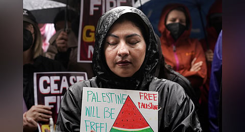 People participate in a sit-in demanding a cease-fire in the Israel-Hamas war at De Longpre Park in Los Angeles, Wednesday, Nov. 15, 2023.