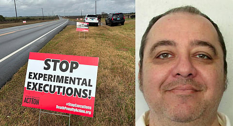 Anti-death penalty signs placed by activists stand along the road heading to Holman Correctional Facility in Atmore, Ala., ahead of the scheduled execution of Kenneth Eugene Smith (right), Thursday, Jan. 25, 2024.