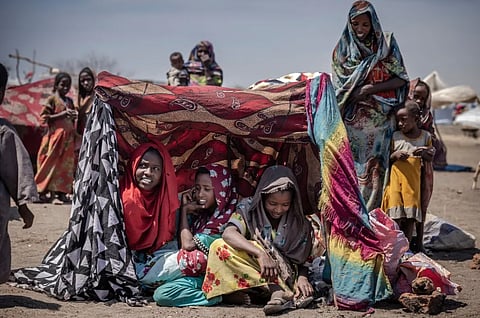 Sudanese girls and women find some shade at a transit centre for refugees in Renk, South Sudan.