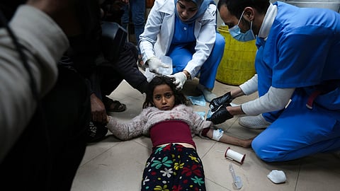 Palestinians wounded in the Israeli bombardment of the Gaza Strip are brought to Al Aqsa hospital in Deir al Balah, Friday, Feb. 23, 2024.