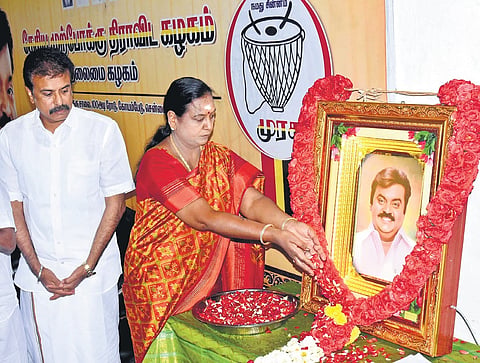 DMDK general secretary Premalatha paying respects to the portrait of party founder Viajayakanth in Chennai on Wednesday.