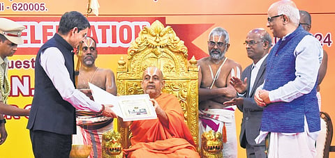 Governor R N Ravi receiving a souvenir at Srimad Andavan college.