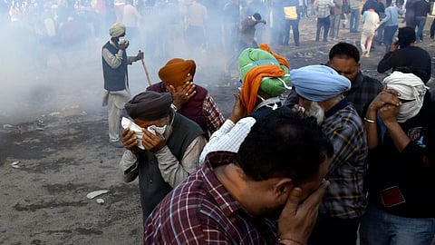 Police use tear gas to disperse farmers gathered at the Punjab-Haryana Shambhu border during their 'Delhi Chalo' march, in Patiala.