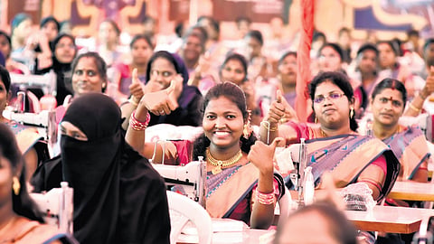 Women beneficiaries at the welfare assistance event, in which laptops and sewing machines were distributed, at Kamrajar Arangam on Tuesday.