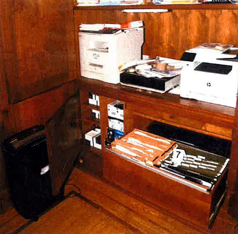 This image, contained in the report from special counsel Robert Hur, shows notebooks in a file cabinet under a printer that were seized in first-floor home office of President Joe Biden in Wilmington, Del., on Jan. 20, 2023, during a search by FBI agents.