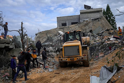 Palestinians search for survivors after an Israeli airstrike on a residential building in Al Zawayda, central Gaza Strip, Sunday, Feb. 18, 2024.