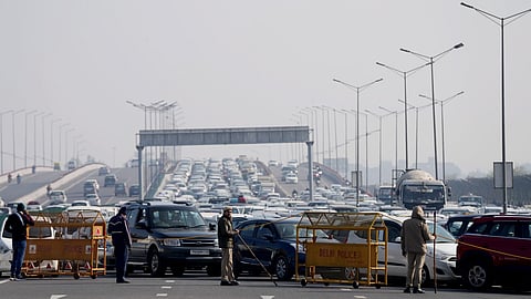 Vehicles stuck in a traffic jam at NH 24 due to a road closure ahead of farmers' protest, in New Delhi, on Feb. 8, 2024.