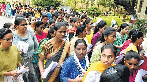 Candidates entering a Group-II exam centre in Tirupati on Sunday.