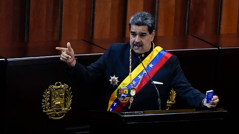 Venezuelan President Nicolas Maduro holds a small copy of his nation's constitution during a ceremony marking the start of the judicial year at the Supreme Court in Caracas, Venezuela, Jan. 31, 2024.